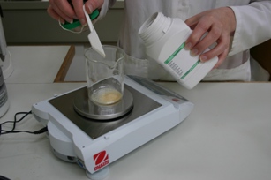 Image of a conservator preparing a gelatine adhesive solution