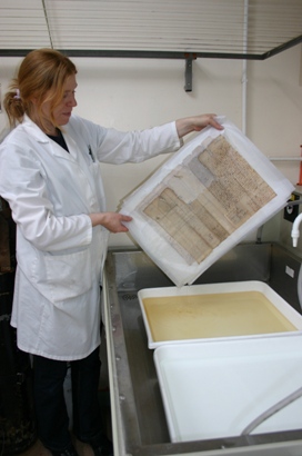 Image of a document being washed in a tray of deionized pH7 water (1)
