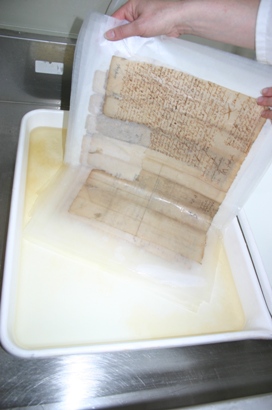 Image of a document being washed in a tray of deionized pH7 water (2)