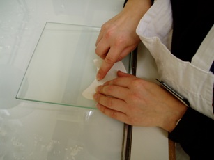Image of a conservator paring a parchment repair piece with a scalpel